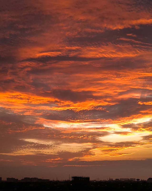 Photo of a sunrise with buildings in the foreground